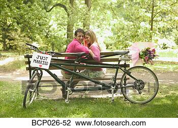 Stock Photo - newlyweds relax 
after a bicycle 
ride. fotosearch 
- search stock 
photos, pictures, 
images, and photo 
clipart