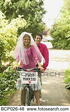 Stock Photo - newlyweds riding 
a tandem bike. 
fotosearch - search 
stock photos, 
pictures, images, 
and photo clipart