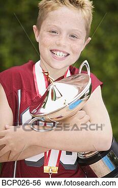 Stock Photo - portrait of a 
boy hugging a 
trophy. fotosearch 
- search stock 
photos, pictures, 
images, and photo 
clipart