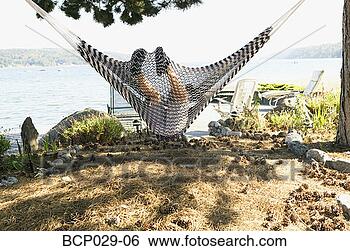 Stock Photo - boy relaxing in 
a hammock at the 
shore. fotosearch 
- search stock 
photos, pictures, 
images, and photo 
clipart