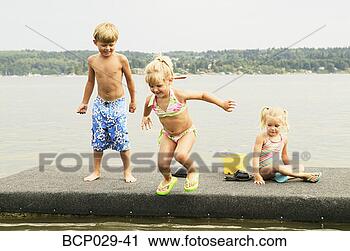 Stock Photography - kids playing on 
a raft. fotosearch 
- search stock 
photos, pictures, 
images, and photo 
clipart