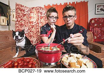 Stock Photograph - couple at home 
having fondue. 
fotosearch - search 
stock photos, 
pictures, images, 
and photo clipart