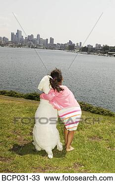 Stock Photo - rear view of girl 
hugging big dog. 
fotosearch - search 
stock photos, 
pictures, images, 
and photo clipart