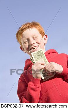 Picture - happy boy holding 
american currency. 
fotosearch - search 
stock photos, 
pictures, images, 
and photo clipart