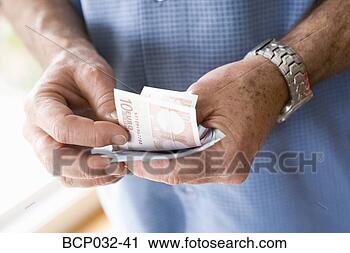Stock Photography - man holding euro 
banknotes. fotosearch 
- search stock 
photos, pictures, 
images, and photo 
clipart