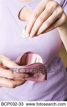 Stock Photo - woman dropping 
coins into change 
purse. fotosearch 
- search stock 
photos, pictures, 
images, and photo 
clipart
