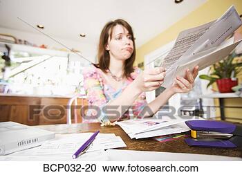 Stock Photography - woman looking 
at bills in mail. 
fotosearch - search 
stock photos, 
pictures, images, 
and photo clipart