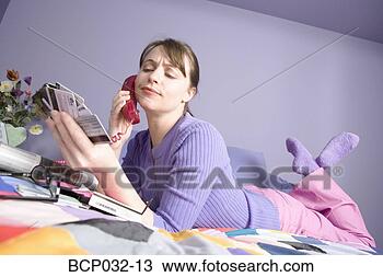 Stock Photo - woman on phone 
holding credit 
cards. fotosearch 
- search stock 
photos, pictures, 
images, and photo 
clipart