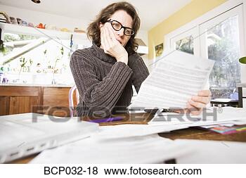 Stock Photo - woman reading 
paperwork. fotosearch 
- search stock 
photos, pictures, 
images, and photo 
clipart