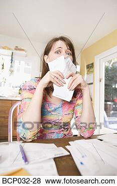 Stock Photo - woman sorting 
through bills 
at home. fotosearch 
- search stock 
photos, pictures, 
images, and photo 
clipart