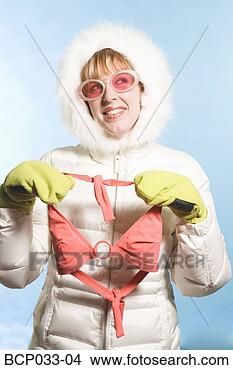 Stock Photo - woman wearing 
parka holding 
bikini top. fotosearch 
- search stock 
photos, pictures, 
images, and photo 
clipart