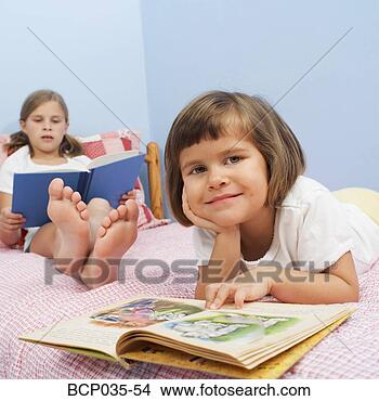 Stock Photo - girls reading 
together on bed. 
fotosearch - search 
stock photos, 
pictures, images, 
and photo clipart