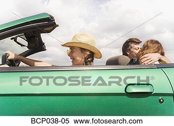 Stock Image - girl pretending 
to drive while 
parents kiss. 
fotosearch - search 
stock photos, 
pictures, images, 
and photo clipart