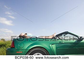 Stock Photography - girl relaxing 
on car. fotosearch 
- search stock 
photos, pictures, 
images, and photo 
clipart