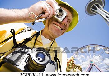 Stock Photography - tourist taking 
a photo. fotosearch 
- search stock 
photos, pictures, 
images, and photo 
clipart