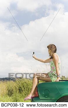 Stock Photo - woman taking photo 
with mobile phone. 
fotosearch - search 
stock photos, 
pictures, images, 
and photo clipart