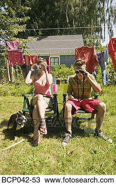 Stock Photo - couple with camera 
and binoculars. 
fotosearch - search 
stock photos, 
pictures, images, 
and photo clipart