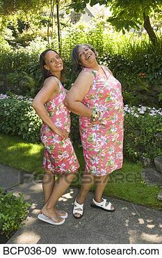 Stock Photograph - two women posing 
for camera. fotosearch 
- search stock 
photos, pictures, 
images, and photo 
clipart