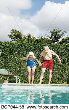 Stock Photo - senior couple 
preparing to dive 
into pool. fotosearch 
- search stock 
photos, pictures, 
images, and photo 
clipart