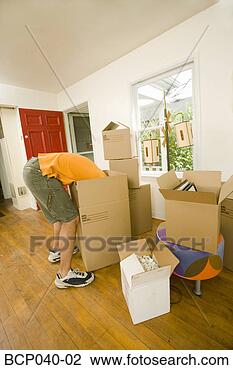 Stock Photo - man with moving 
boxes in new home. 
fotosearch - search 
stock photos, 
pictures, images, 
and photo clipart