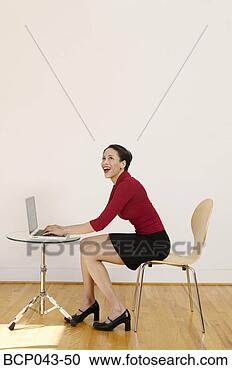 Stock Photography - laughing woman 
using laptop. 
fotosearch - search 
stock photos, 
pictures, images, 
and photo clipart