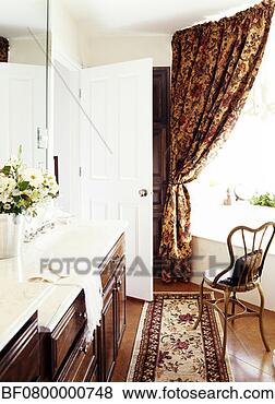 Stock Photo - a chair is kept 
near the bathtub 
in an elegant 
bathroom. fotosearch 
- search stock 
photos, pictures, 
images, and photo 
clipart