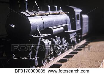 Stock Image - a model train 
engine rests on 
its miniature 
metal tracks. 
fotosearch - search 
stock photos, 
pictures, images, 
and photo clipart