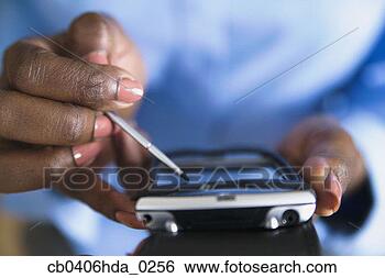 Stock Photo - close-up of a 
woman operating 
a hand held digital 
device. fotosearch 
- search stock 
photos, pictures, 
images, and photo 
clipart