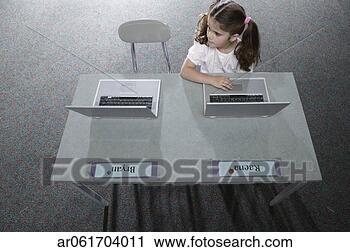 Stock Photography - high angle view 
of a young girl 
sitting in a classroom 
at school. fotosearch 
- search stock 
photos, pictures, 
images, and photo 
clipart