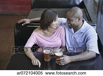 Stock Image - high angle view 
of a young couple 
sitting at a restaurant 
table with. fotosearch 
- search stock 
photos, pictures, 
images, and photo 
clipart