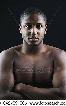 Stock Image - portrait of a 
teenage boy standing 
bare chest with 
arms folded. fotosearch 
- search stock 
photos, pictures, 
images, and photo 
clipart