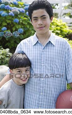 Stock Photo - portrait of a 
young boys standing 
with a teenage 
boy. fotosearch 
- search stock 
photos, pictures, 
images, and photo 
clipart