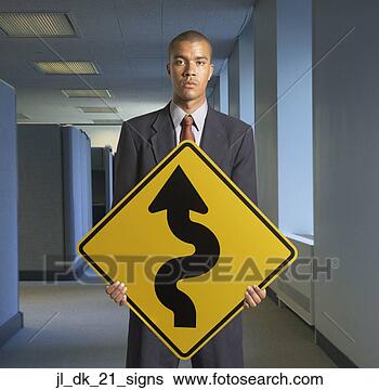 Stock Photo - portrait of young 
man holding a 
curved road ahead 
signboard. fotosearch 
- search stock 
photos, pictures, 
images, and photo 
clipart