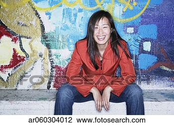 Stock Photo - portrait of a 
young woman sitting 
in front of a 
graffiti wall. 
fotosearch - search 
stock photos, 
pictures, images, 
and photo clipart