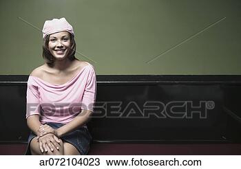 Stock Photo - portrait of a 
young woman sitting 
on a bench looking 
at camera smiling. 
fotosearch - search 
stock photos, 
pictures, images, 
and photo clipart