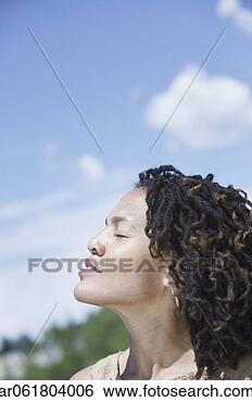Stock Photo - side profile of 
a woman sitting 
outdoors with 
eyes closed. fotosearch 
- search stock 
photos, pictures, 
images, and photo 
clipart