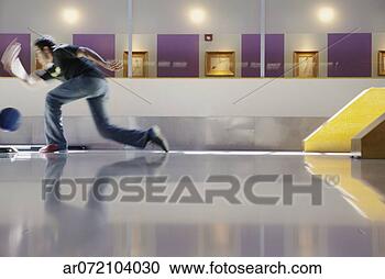 Stock Photography - side profile of 
a young man bowling 
in a bowling alley. 
fotosearch - search 
stock photos, 
pictures, images, 
and photo clipart