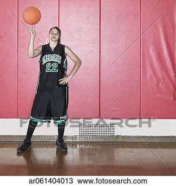 Stock Photo - teenage girl spinning 
a basket ball 
on her finger 
on a basketball. 
fotosearch - search 
stock photos, 
pictures, images, 
and photo clipart