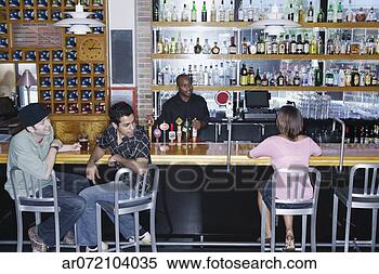 Stock Image - two young men 
sitting in a bar 
looking at a young 
woman. fotosearch 
- search stock 
photos, pictures, 
images, and photo 
clipart