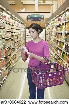 Stock Photo - woman holding 
a shopping basket 
and reading her 
shopping list 
at a. fotosearch 
- search stock 
photos, pictures, 
images, and photo 
clipart