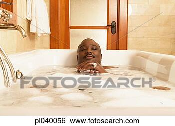 Stock Photo - young man in a 
bubble bath. fotosearch 
- search stock 
photos, pictures, 
images, and photo 
clipart