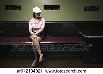 Stock Photography - young woman sitting 
on a bench looking 
down. fotosearch 
- search stock 
photos, pictures, 
images, and photo 
clipart