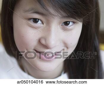 Stock Photo - close-up of a 
teenage girl looking 
at camera smiling, 
beijing, china. 
fotosearch - search 
stock photos, 
pictures, images, 
and photo clipart