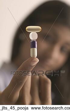 Stock Photography - close-up of tower 
of capsules and 
a tablet balanced 
on a young. fotosearch 
- search stock 
photos, pictures, 
images, and photo 
clipart