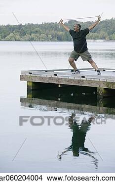 Stock Photo - elderly man exercising 
on a pier. fotosearch 
- search stock 
photos, pictures, 
images, and photo 
clipart
