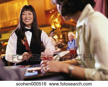 Stock Photo - female croupier 
dealing cards. 
fotosearch - search 
stock photos, 
pictures, images, 
and photo clipart