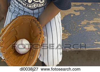 Picture - high angle view 
of a young boy 
wearing a baseball 
mitt holding a 
ball. fotosearch 
- search stock 
photos, pictures, 
images, and photo 
clipart