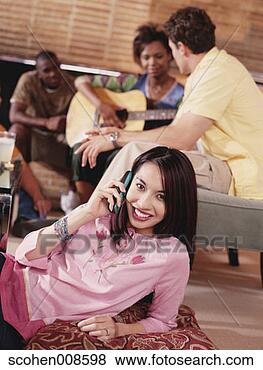 Stock Photo - portrait of a 
young woman talking 
on a mobile phone 
with a young. 
fotosearch - search 
stock photos, 
pictures, images, 
and photo clipart