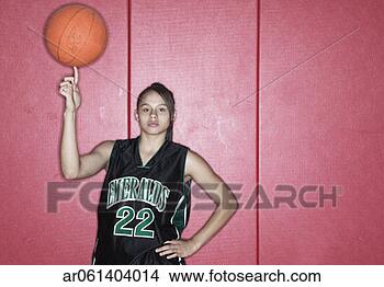 Stock Photo - teenage girl spinning 
a basketball on 
her finger on 
a basketball court. 
fotosearch - search 
stock photos, 
pictures, images, 
and photo clipart