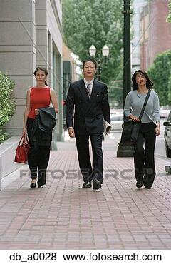 Stock Photo - three business 
executives walking 
on the side walk. 
fotosearch - search 
stock photos, 
pictures, images, 
and photo clipart